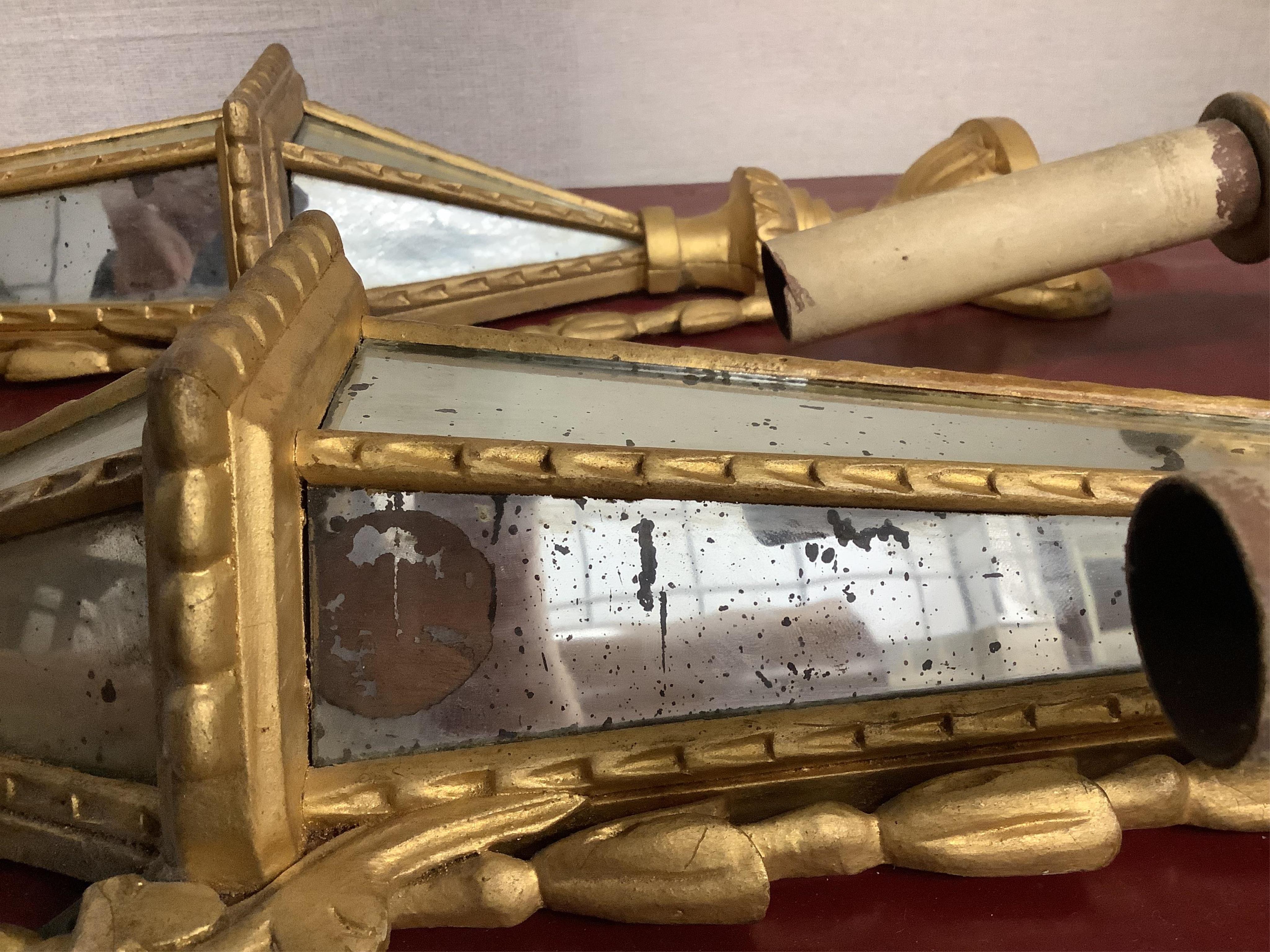 A pair of Venetian style mirrored giltwood and composition two branch wall lights, height 81cm. Condition - poor